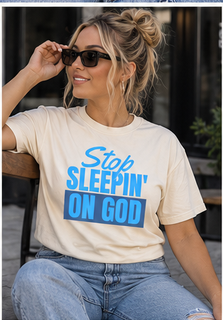 Model wearing Stop Sleepin’ On God cream blue tee