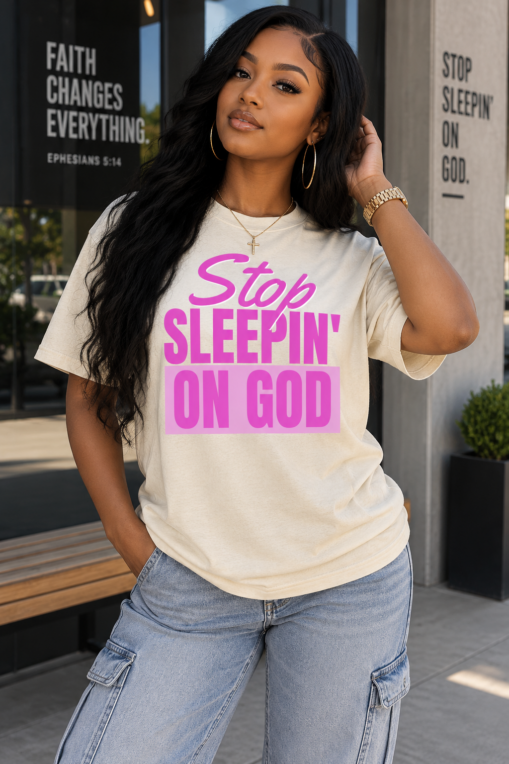 Model wearing Stop Sleepin’ On God cream and pink tee